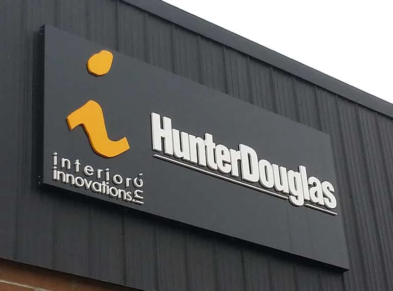 Dimensional letters and logo on a dark metal building