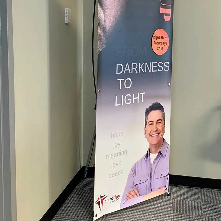 Retractable banner stand with a printed portrait
